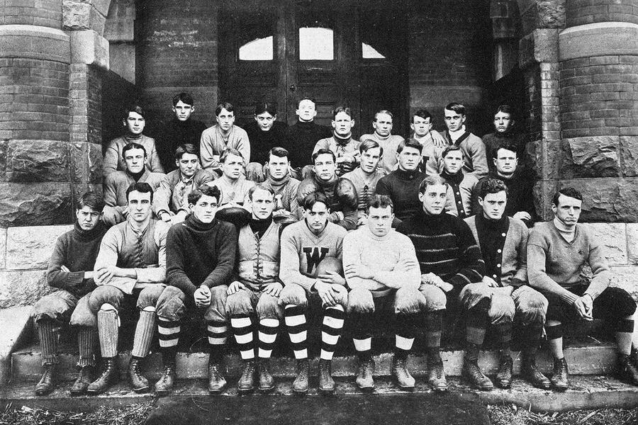 Dated 1908, this is an old photo of several young men are sitting on the steps of Old Main